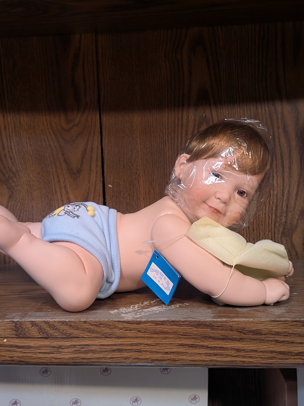 Lifelike Blue-Accented Baby Doll with Plush Pillow
